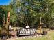 This lovely backyard features a cozy seating area with shade trees to provide the perfect relaxation spot at 6312 Bill Ledford Rd, Vale, NC 28168