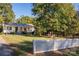 Charming single-story home with a large front yard, a white picket fence, and a welcoming front porch at 6312 Bill Ledford Rd, Vale, NC 28168