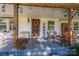 Charming front porch featuring a cozy seating area, decorative lanterns, and a welcoming wreath on the door at 6312 Bill Ledford Rd, Vale, NC 28168