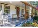 Spacious front porch with a seating area, decorative accents, and a welcoming entrance at 6312 Bill Ledford Rd, Vale, NC 28168