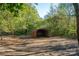 Outdoor metal storage shed for equipment and tools, set against the backdrop of a wooded area at 6312 Bill Ledford Rd, Vale, NC 28168