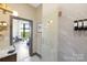 Luxurious bathroom with glass shower, sleek fixtures, and view into living space at 715 N Church St # 816, Charlotte, NC 28202