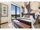 Chic bedroom features large windows, designer walls, and a comfortable bed and bench at 715 N Church St # 816, Charlotte, NC 28202