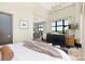Bright bedroom featuring city views, modern dresser and TV, with an adjacent kitchen at 715 N Church St # 816, Charlotte, NC 28202