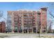 Contemporary brick building with large windows and balconies under a clear blue sky at 715 N Church St # 816, Charlotte, NC 28202