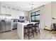 Modern kitchen with stainless steel appliances, white cabinets, and a large island with counter seating and outdoor views at 715 N Church St # 816, Charlotte, NC 28202