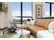 Bright living room features a large window, leather couch, and modern decor at 715 N Church St # 816, Charlotte, NC 28202