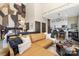 Open-concept living area showcases modern decor, a kitchen with white cabinets, and an accent wall with unique artwork at 715 N Church St # 816, Charlotte, NC 28202