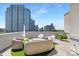 A well-appointed roof deck with stylish outdoor seating and panoramic city views at 715 N Church St # 816, Charlotte, NC 28202
