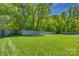 Expansive backyard featuring lush green grass and a tall wood fence at 7300 Chatterbird Ct, Charlotte, NC 28226