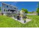 Enjoy this home's backyard patio with seating, fire pit, and gazebo, perfect for outdoor gatherings and relaxation at 7300 Chatterbird Ct, Charlotte, NC 28226