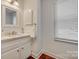 Bathroom with updated fixtures, natural light, vanity with Carrara Marble top, and cabinet storage at 7300 Chatterbird Ct, Charlotte, NC 28226
