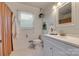 Clean bathroom featuring tile flooring, a window, and a sleek vanity at 7300 Chatterbird Ct, Charlotte, NC 28226