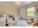 Cozy Bedroom featuring a crib, chair, and a large window at 7300 Chatterbird Ct, Charlotte, NC 28226