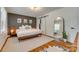 Bright bedroom with hardwood floors, sliding closet doors, and decorative mirror at 7300 Chatterbird Ct, Charlotte, NC 28226