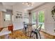 Sunlit breakfast nook with modern light fixtures, stainless appliances, and outdoor access at 7300 Chatterbird Ct, Charlotte, NC 28226