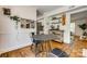 Stylish dining area featuring modern table and chair set, hardwood floors, and access to the kitchen at 7300 Chatterbird Ct, Charlotte, NC 28226