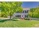 Charming two-story home with a well-manicured lawn, mature trees, and classic curb appeal at 7300 Chatterbird Ct, Charlotte, NC 28226