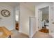 Upstairs hallway with access to bedrooms and updated fixtures at 7300 Chatterbird Ct, Charlotte, NC 28226