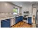 Modern kitchen with white and blue cabinets, stainless steel appliances, and granite countertops at 7300 Chatterbird Ct, Charlotte, NC 28226