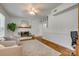 Bright living room features a white brick fireplace, wood floors, and comfortable seating at 7300 Chatterbird Ct, Charlotte, NC 28226