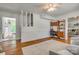 Living area with hardwood floors, a staircase, and a built-in desk and shelves at 7300 Chatterbird Ct, Charlotte, NC 28226