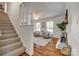 Bright living room with hardwood floors, fireplace, large windows, and neutral color palette at 7300 Chatterbird Ct, Charlotte, NC 28226