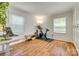 Well-lit home office or flex space with hardwood floors and bright windows at 7300 Chatterbird Ct, Charlotte, NC 28226