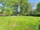 A large, flat backyard offers ample space and mature trees at 803 Blackmon St, Rock Hill, SC 29730