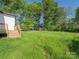 Expansive backyard featuring lush green grass and mature trees, perfect for outdoor activities at 803 Blackmon St, Rock Hill, SC 29730