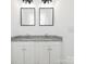 Bathroom with double vanity featuring framed mirrors and granite countertop at 803 Blackmon St, Rock Hill, SC 29730