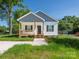 Charming home featuring white siding, a covered front porch, and well-maintained landscaping at 803 Blackmon St, Rock Hill, SC 29730