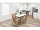 Bright kitchen features stainless steel appliances, stone countertops, and dining area with wood table at 803 Blackmon St, Rock Hill, SC 29730