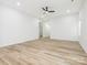 Bright and open living room featuring modern ceiling fan, wood-look floors and neutral paint at 803 Blackmon St, Rock Hill, SC 29730