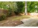 Backyard featuring mature trees, partial grass, wooden fence, and deck at 846 Gist Rd, Rock Hill, SC 29732