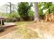 Backyard with lush trees and wooden fence and partial wooden deck at 846 Gist Rd, Rock Hill, SC 29732