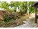 Landscaped backyard features a wooden deck, lush trees, and fenced yard at 846 Gist Rd, Rock Hill, SC 29732