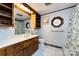 Bathroom featuring wood cabinetry, a decorative window, and tiled floors at 846 Gist Rd, Rock Hill, SC 29732