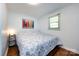 Bright bedroom featuring hardwood floors, white walls, and a comfortable bed at 846 Gist Rd, Rock Hill, SC 29732