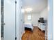 Bright bedroom with a bed, wood floors and view through the open doorway at 846 Gist Rd, Rock Hill, SC 29732