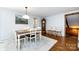 Bright dining room boasts wood floors, a rug, a grandfather clock, and 3 chairs on display at 846 Gist Rd, Rock Hill, SC 29732