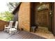 Charming front porch with rocking chairs and brick accents near front door at 846 Gist Rd, Rock Hill, SC 29732