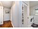 Hallway with hardwood floors leading to a laundry room with white appliances at 846 Gist Rd, Rock Hill, SC 29732