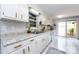 Kitchen featuring white cabinets, dual basin sink, stainless appliances, and tiled floors at 846 Gist Rd, Rock Hill, SC 29732