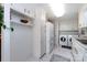 Bright laundry room featuring white appliances, cabinets, and stylish tile flooring at 846 Gist Rd, Rock Hill, SC 29732