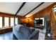 Cozy living room with a vaulted beamed ceiling, a television, and wood paneled walls at 846 Gist Rd, Rock Hill, SC 29732