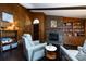 Cozy living room featuring a brick fireplace, wood paneling, and comfortable seating at 846 Gist Rd, Rock Hill, SC 29732