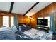 Comfortable living room featuring wood paneling, natural lighting, and a vaulted ceiling at 846 Gist Rd, Rock Hill, SC 29732