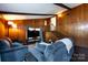 Open living room showcasing wood paneling, stairs, and a vaulted ceiling at 846 Gist Rd, Rock Hill, SC 29732