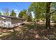 Expansive backyard with mature trees offers a serene setting perfect for relaxation and outdoor activities at 880 Legion Club Rd, Salisbury, NC 28146